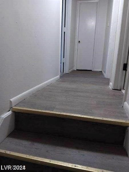 stairway featuring hardwood / wood-style floors