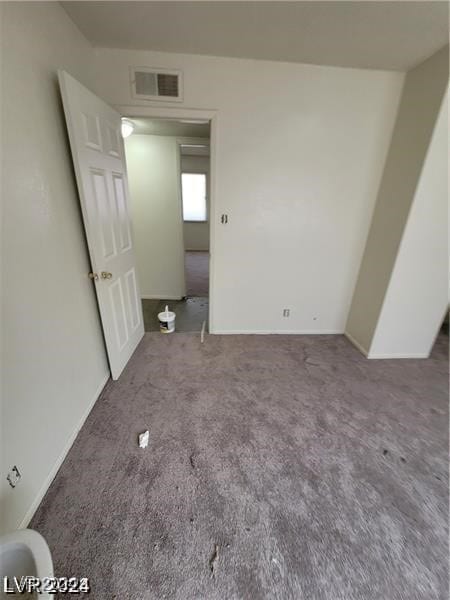 empty room with dark carpet