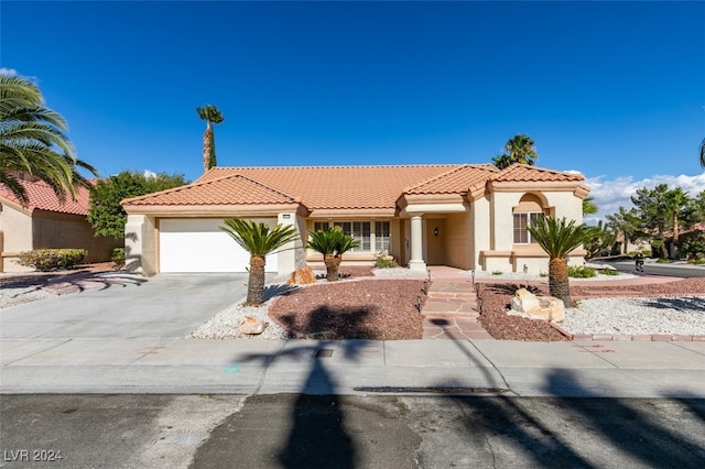 mediterranean / spanish home with a garage