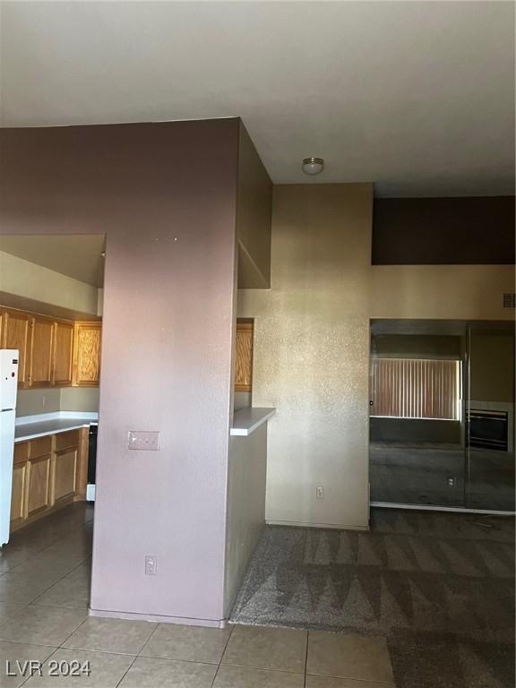 kitchen featuring white fridge and light tile patterned flooring