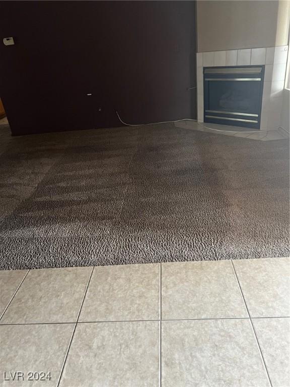 interior space featuring tile patterned floors and a tiled fireplace