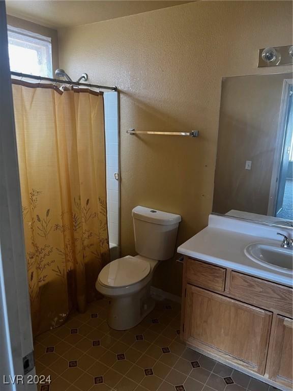 full bathroom featuring toilet, shower / tub combo, tile patterned floors, and vanity