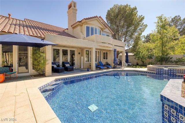 view of pool featuring an in ground hot tub, a patio, and an outdoor hangout area