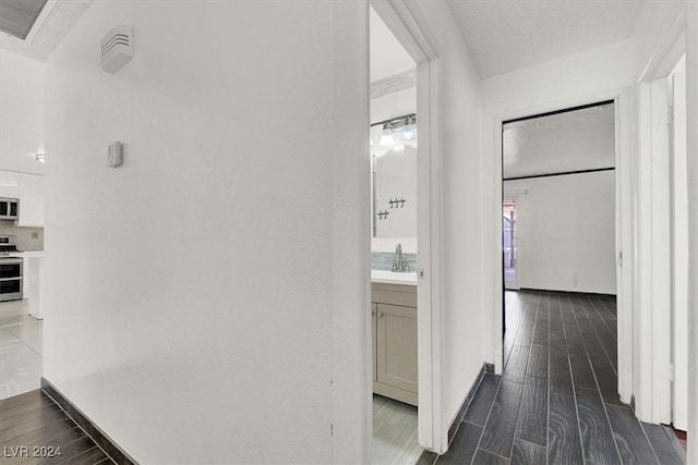 hallway with dark hardwood / wood-style floors and sink