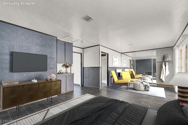 living room featuring a textured ceiling and dark hardwood / wood-style flooring