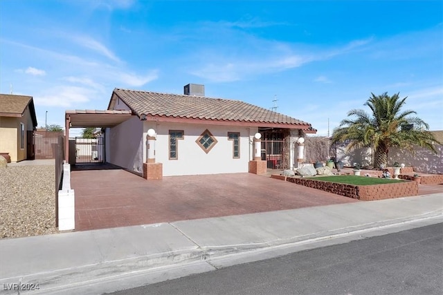 mediterranean / spanish home featuring a carport