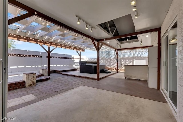 view of patio / terrace with a hot tub