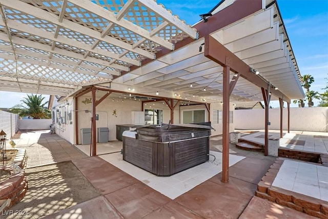 view of patio / terrace featuring a pergola and a hot tub