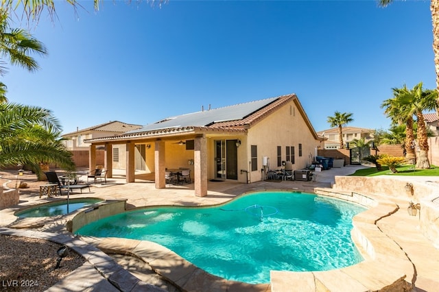 view of swimming pool featuring a patio area and an in ground hot tub