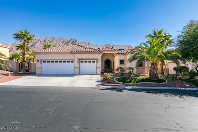 mediterranean / spanish-style house featuring a mountain view and a garage