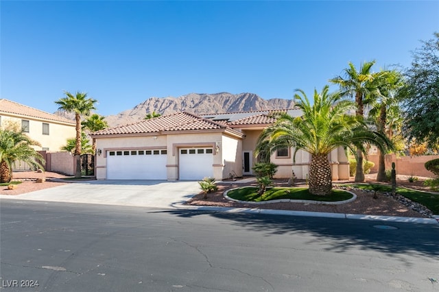 mediterranean / spanish-style house featuring a mountain view and a garage