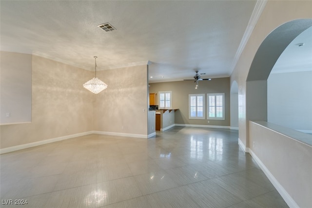 unfurnished living room featuring ceiling fan and ornamental molding