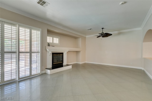 unfurnished living room with ceiling fan and crown molding