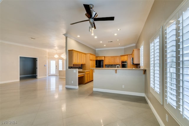 kitchen with a kitchen breakfast bar, black refrigerator, crown molding, oven, and kitchen peninsula