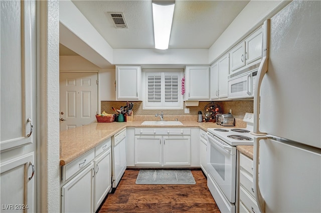 kitchen with white appliances, decorative backsplash, sink, and white cabinetry