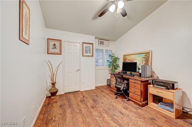 office space with a ceiling fan, baseboards, light wood-style flooring, and lofted ceiling