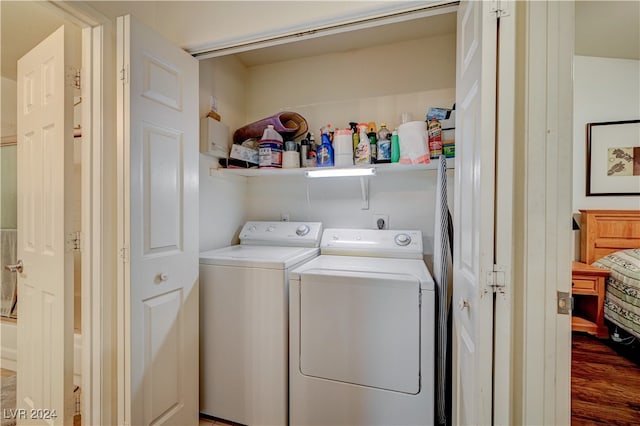 washroom featuring dark hardwood / wood-style floors and washing machine and clothes dryer