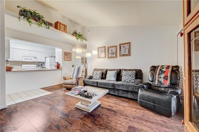 living room featuring high vaulted ceiling and hardwood / wood-style floors