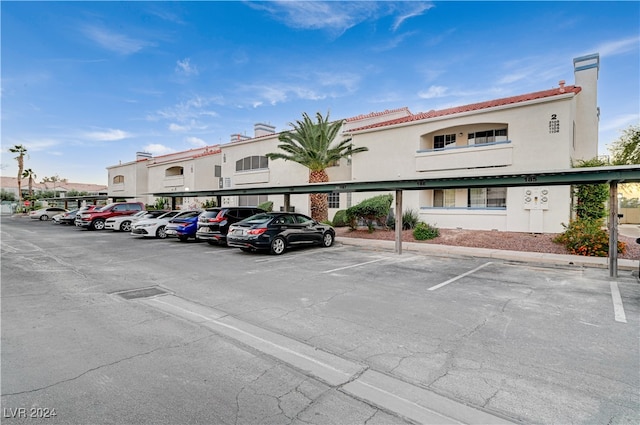 view of vehicle parking with a carport