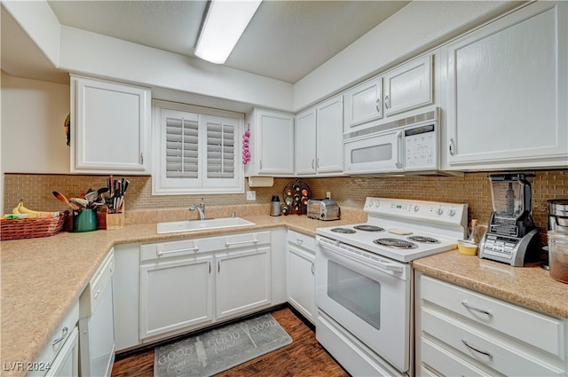 kitchen featuring white appliances, tasteful backsplash, sink, white cabinetry, and dark hardwood / wood-style floors