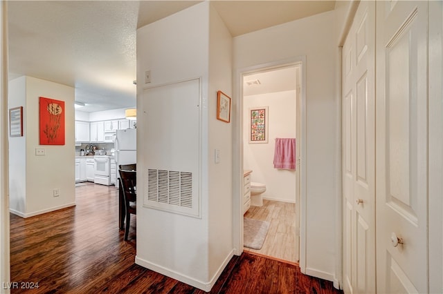 corridor with hardwood / wood-style floors