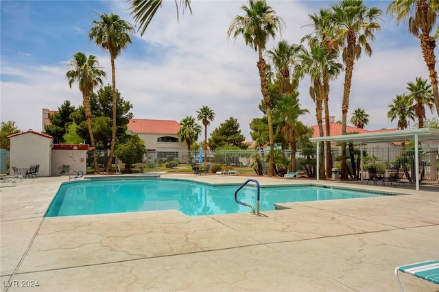 pool featuring a patio and fence