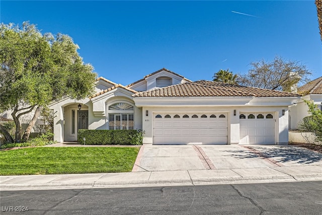 view of front facade featuring a front yard and a garage