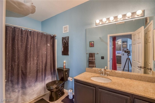 9975 Peace Way Unit 1058, Las Vegas, NV 89147 - full bathroom featuring vanity, toilet, a shower with curtain, a textured wall, and baseboards