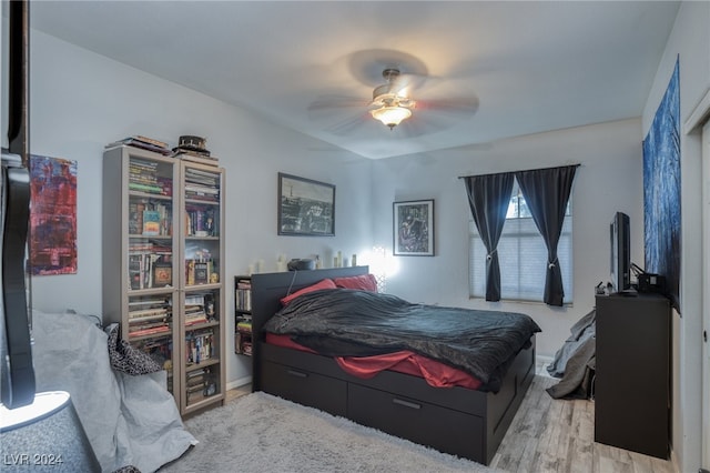 bedroom with light hardwood / wood-style flooring and ceiling fan