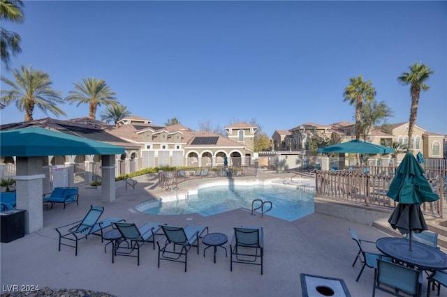 9975 Peace Way Unit 1058, Las Vegas, NV 89147 - community pool featuring a patio area, a gazebo, and a residential view