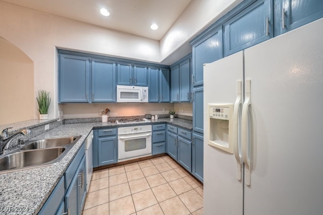 kitchen with blue cabinetry, light tile patterned flooring, sink, and appliances with stainless steel finishes