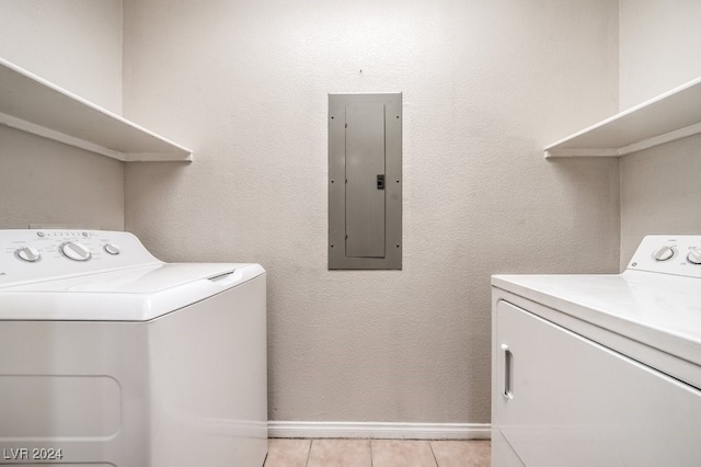 laundry area with light tile patterned floors, separate washer and dryer, and electric panel