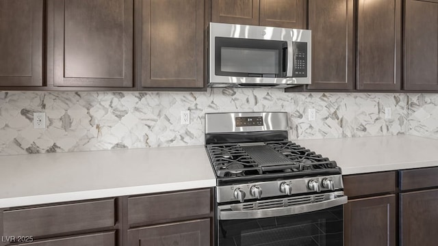 kitchen featuring dark brown cabinets, appliances with stainless steel finishes, light countertops, and backsplash