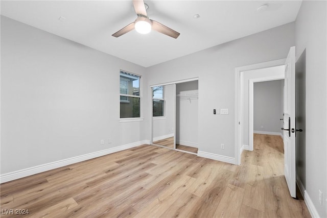 unfurnished bedroom with a closet, ceiling fan, and light hardwood / wood-style flooring