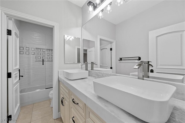 full bathroom featuring tile patterned flooring, vanity, toilet, and shower / bath combination with glass door