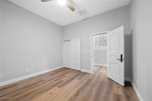 unfurnished bedroom with a closet, ceiling fan, and light hardwood / wood-style flooring