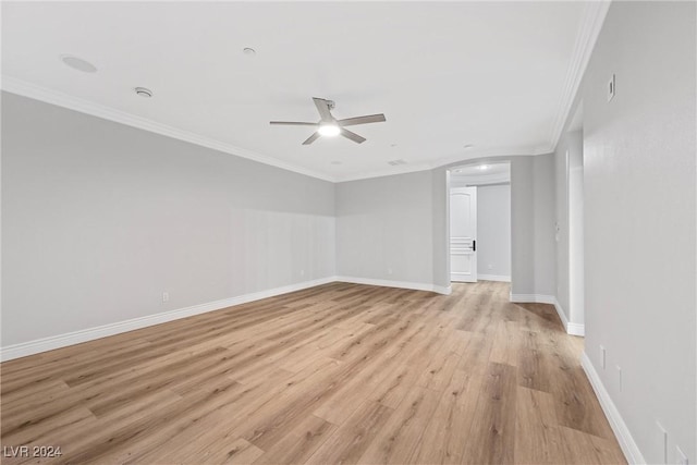 unfurnished room with a ceiling fan, light wood-style flooring, baseboards, and crown molding