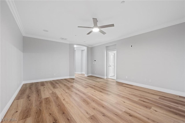 unfurnished room with visible vents, ornamental molding, ceiling fan, light wood-type flooring, and baseboards