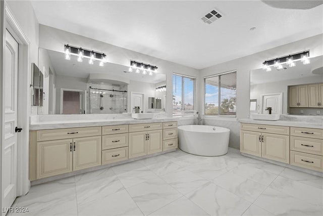 full bath featuring a soaking tub, marble finish floor, a sink, and a stall shower