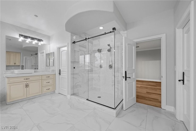 bathroom featuring marble finish floor, baseboards, a shower stall, and vanity