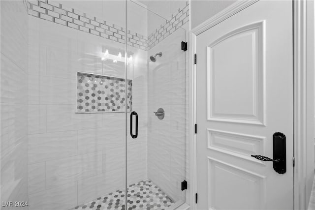 bathroom with a shower with shower door