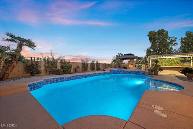 view of swimming pool with a patio area, a fenced backyard, and a pool with connected hot tub