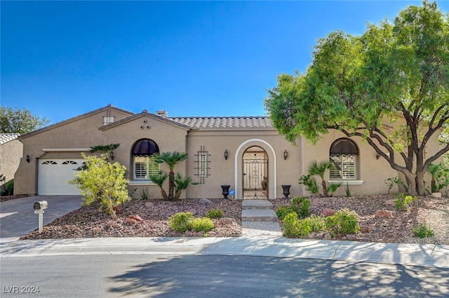 mediterranean / spanish home featuring a garage