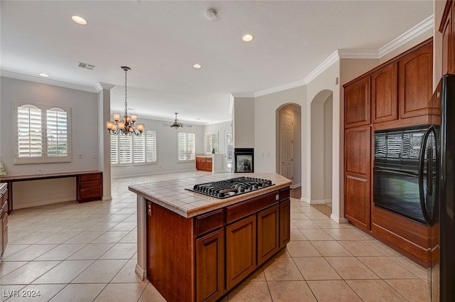 kitchen featuring ornamental molding, black appliances, tile counters, and plenty of natural light