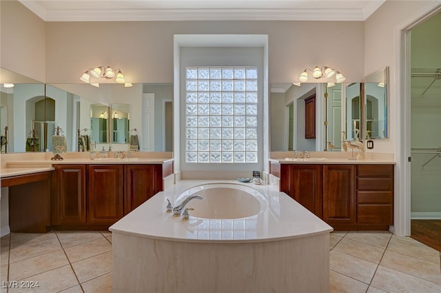 bathroom with a bathing tub, crown molding, vanity, and tile patterned flooring