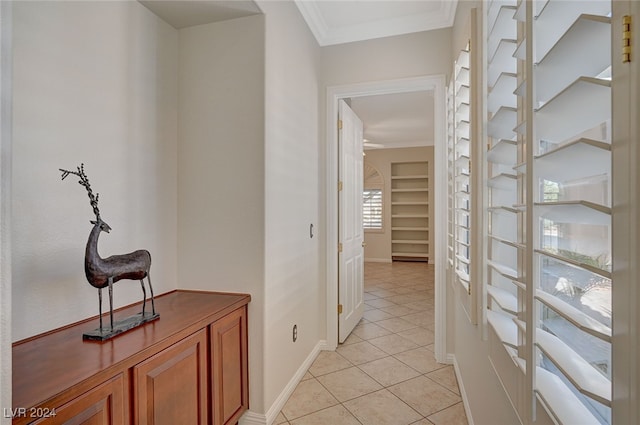 hall with ornamental molding and light tile patterned floors