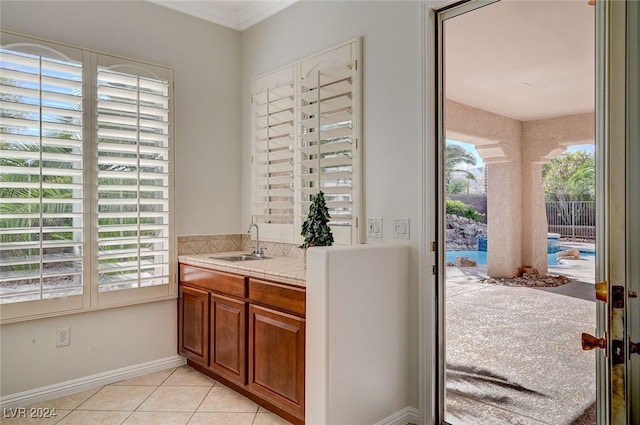 bathroom with a wealth of natural light, tile patterned floors, and vanity