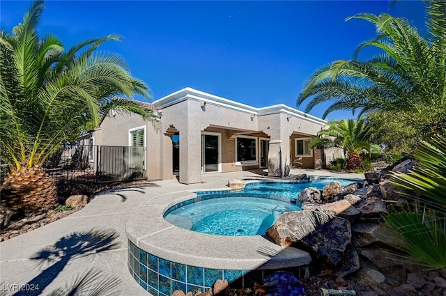 view of swimming pool featuring an in ground hot tub and a patio area