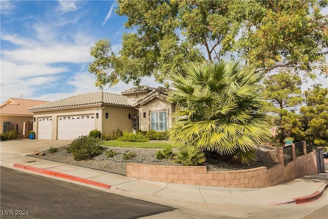 view of front facade featuring fence, stucco siding, concrete driveway, an attached garage, and a tile roof
