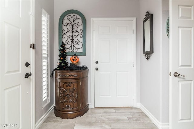 entryway featuring baseboards and light wood-type flooring